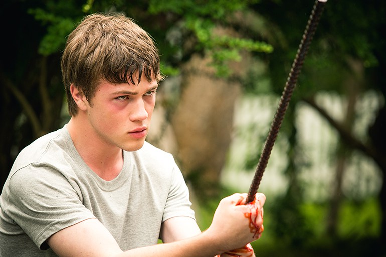 Oscar (Connor Jessup) holding a bloody piece of rebar.
